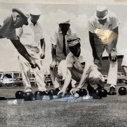 Black and white photo of using a measure to determine the final score of an end. 